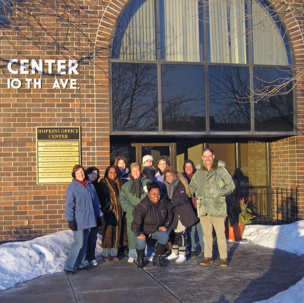 Staff pose for a winter photo outside CAPSH's Hopkins office in 2008