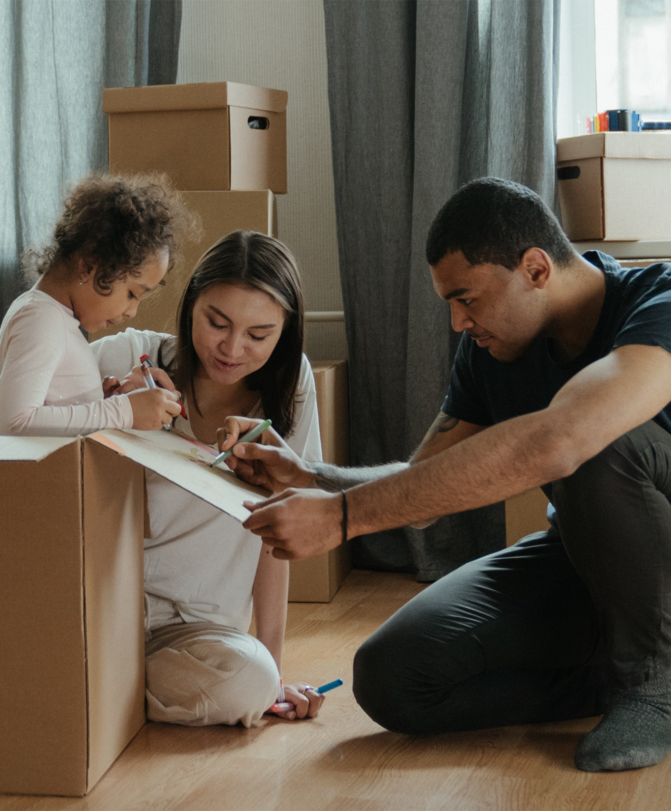 child, mother, and father moving into an apartment