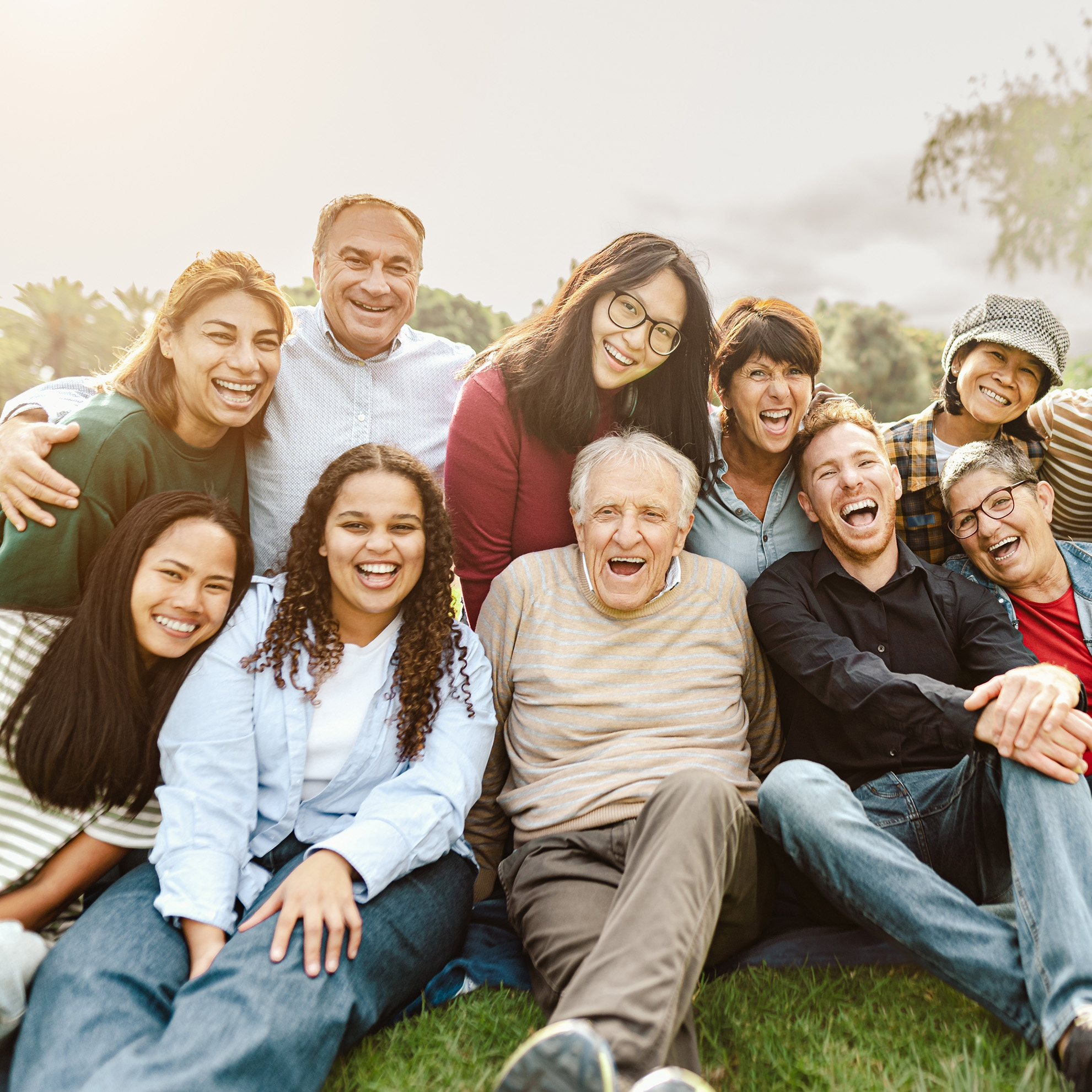 group of racially and age diverse people sitting outside
