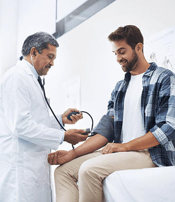 doctor checking a patient's blood pressure