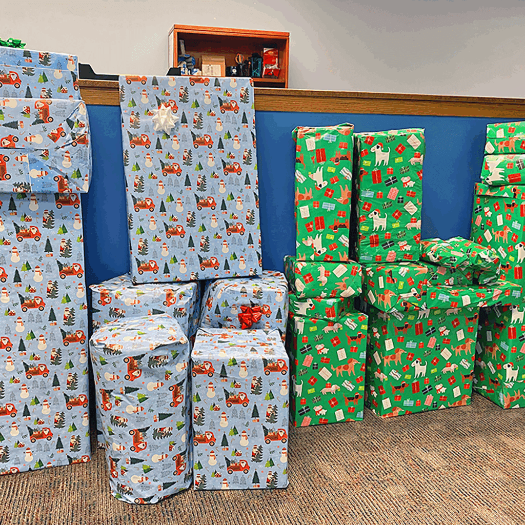 stack of wrapped gifts ready to be picked up by sponsored families