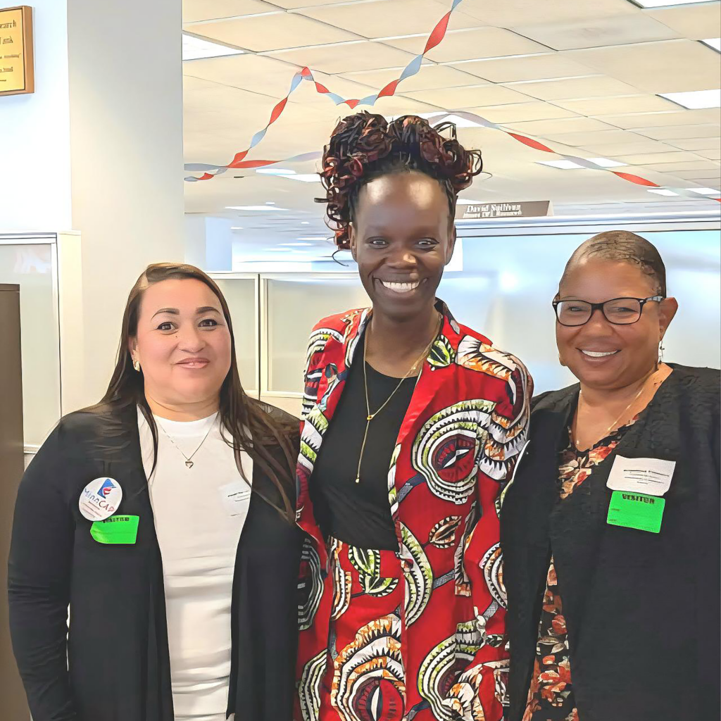 Two CAP-HC staff and Rep. Momanyi-Hiltsley smiling on MinnCAP Advocacy Day