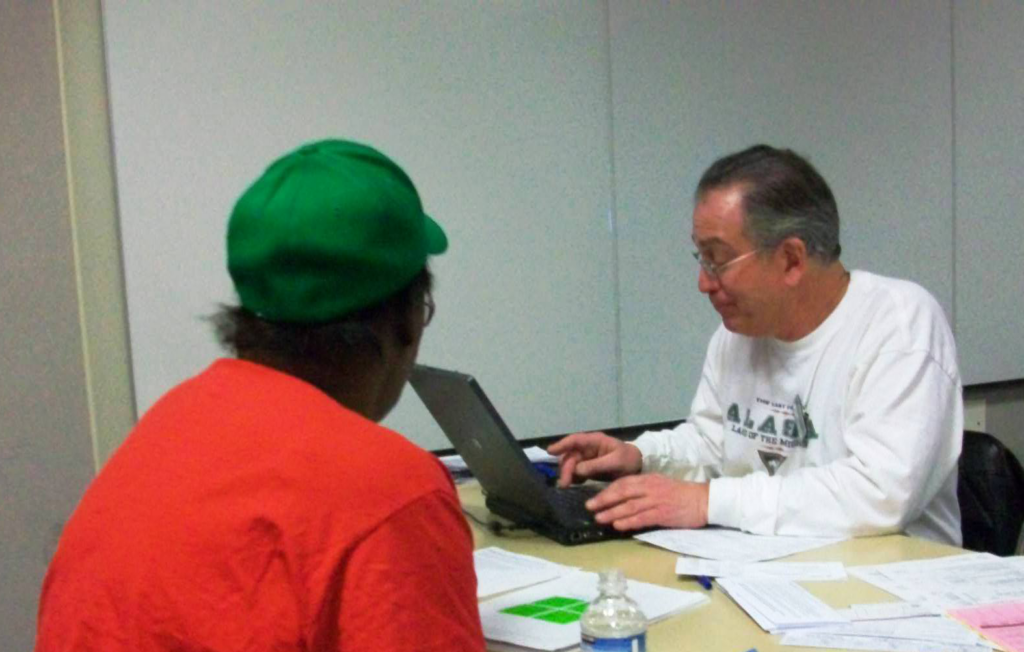Staff member helps a client at a 2009 tax filing assistance event