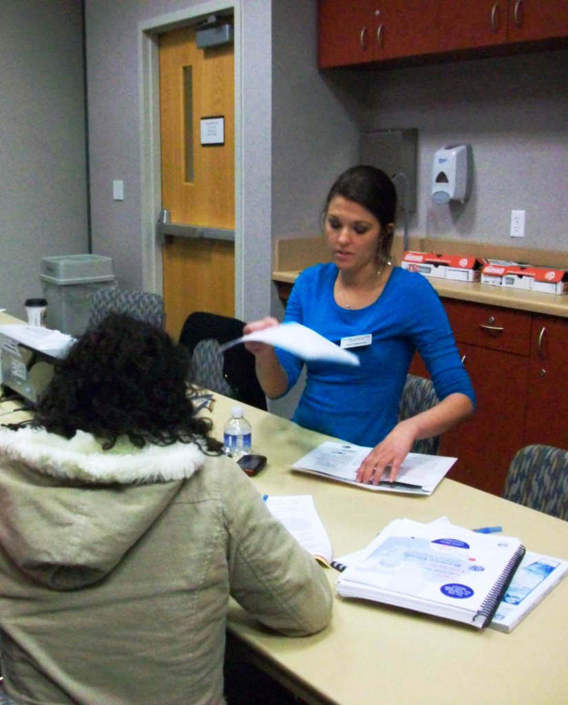 Staff member helps a client at a 2009 tax filing assistance event
