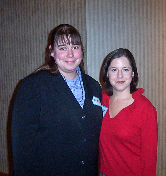 2 staff members pose for a photo at the 2006 Annual Meeting
